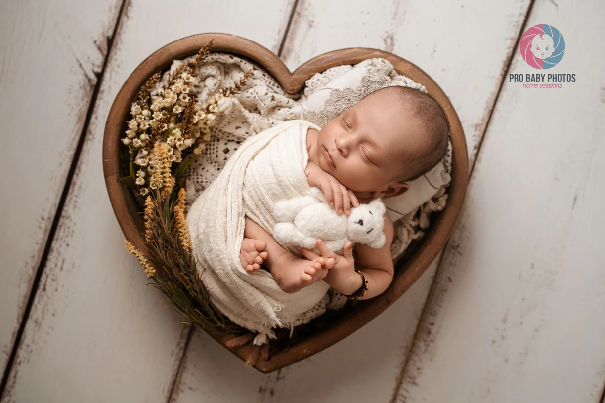 Wrapped baby sleeping in a rustic round basket