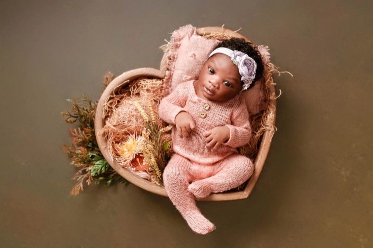 At-home newborn baby photography with soft studio-style lighting