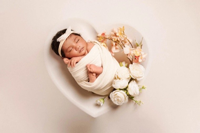 Newborn baby wrapped during a home photography session