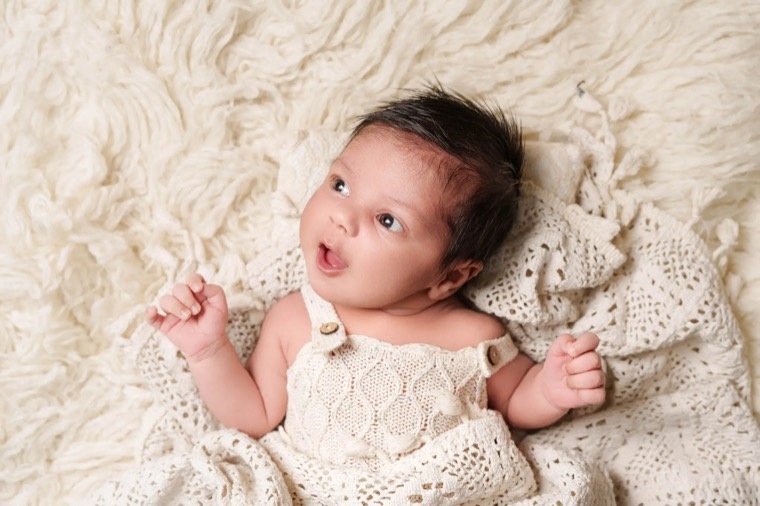 Newborn baby photography home session with calm posing